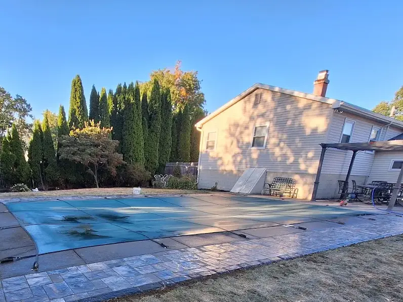 Custom outdoor living space and pool surround in Clifton Park NY